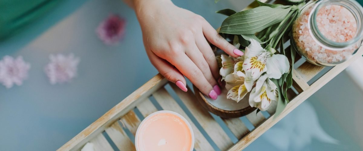 Elegant spa setting with flowers, bath salts, and calming ambiance for ultimate relaxation.